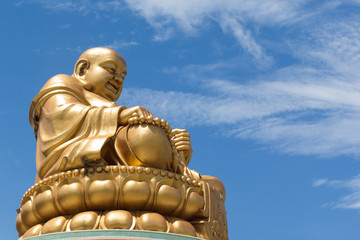 Fototapeta premium Golden Chinese buddha on blue sky background
