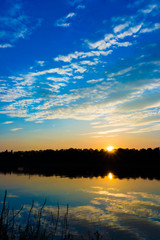 Fototapeta premium sunset on the river. dramatic sunset over a lake