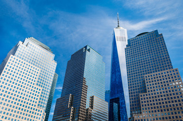 Skyscrapers rising up to sky on Lower Manhattan - obrazy, fototapety, plakaty