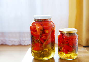 two glass jars with marinated tomatoes homemade
