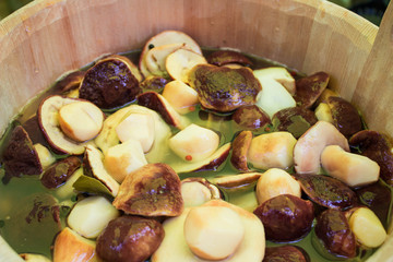 mushrooms marinated in a wooden barrel