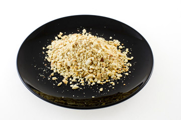 Crushing Peanuts for thai noodle on black plate isolate white ba