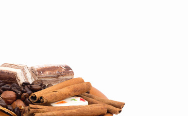 Sweets, cinnamon, nuts and coffee beans on a saucer