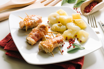 Bacon rolls, chicken, cheese with potatoes and onions