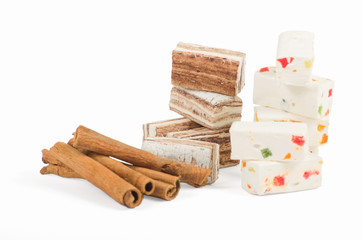 Sweets and cinnamon sticks isolated on white background
