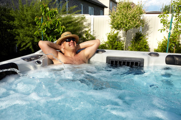Man having massage in  hot tub spa. - obrazy, fototapety, plakaty