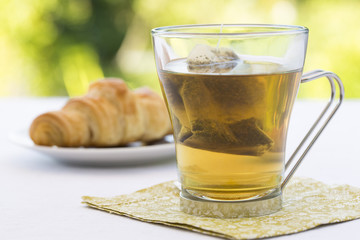 Tea and croissant in garden