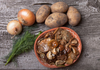 Salty mashrooms, potato, onion, dill and grain in a bowl on a ol