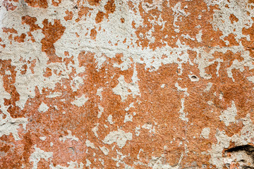 Concrete surface with the remains of whitewash and orange paint