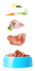 Concept of food for pets. Food falling in pet's bowl isolated