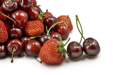 strawberries and cherries on white background