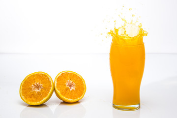 Orange Juice Splash at a tall Glass. Perfect Motion Freeze.
