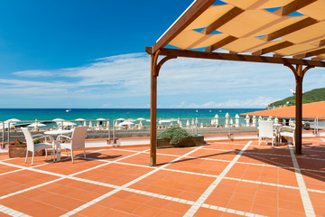 orange tiled terrace with desk and chairs with shadow roof