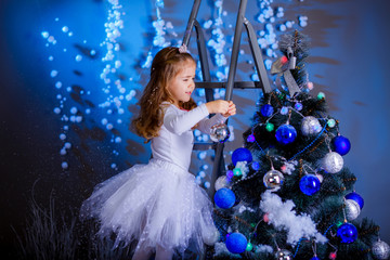 little girl in suit Snow Maiden near the Christmas tree
