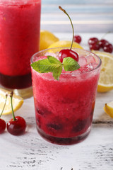 Fresh cold cherry cocktail with mint, ice and lemon