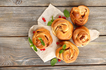 Tasty buns with berries on table close-up