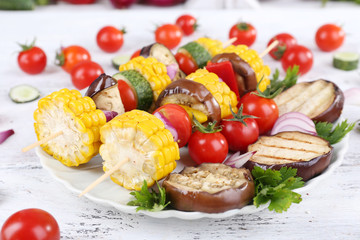 Sliced vegetables on picks on plate on table close-up