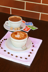 Cup of coffee with cute drawing in cafe