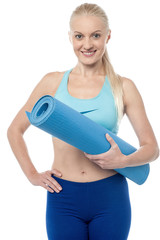 Fitness woman with an excercise mat