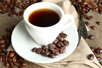 Cup of coffee and coffee beans with chocolate glaze