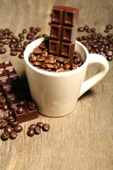 Cup with coffee beans and dark chocolate glaze