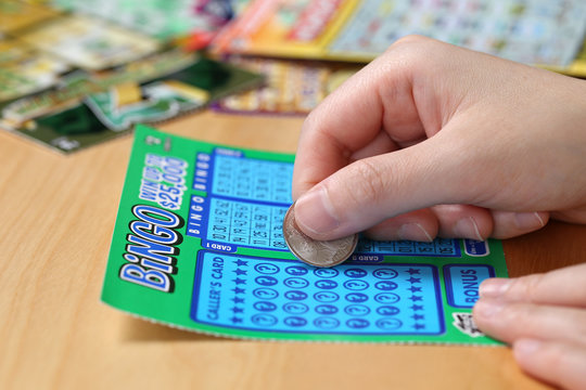 Woman scratching lottery ticket called Bingo.