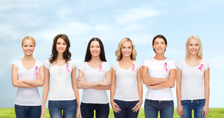 smiling women with pink cancer awareness ribbons