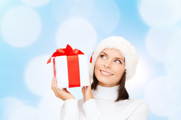 smiling woman in santa helper hat with gift box