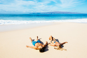 Fototapeta na wymiar Couple Relaxing on the Beach
