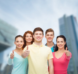 group of smiling teenagers over city background