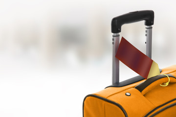 Orange suitcase with blank label at airport.
