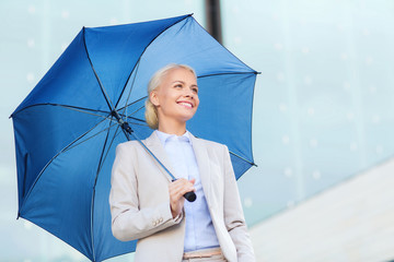 young smiling businesswoman with umbrella outdoors