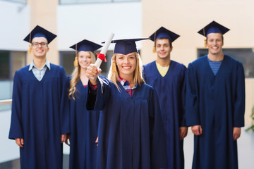 group of smiling students in mortarboards