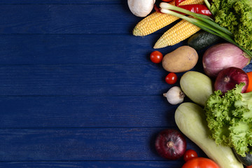 Fototapeta na wymiar Fresh organic vegetables on wooden background