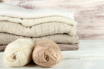 Fototapeta na wymiar Knitting clothes and yarn on wooden background