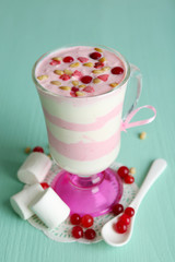 Cranberry milk dessert in glass  on color wooden background