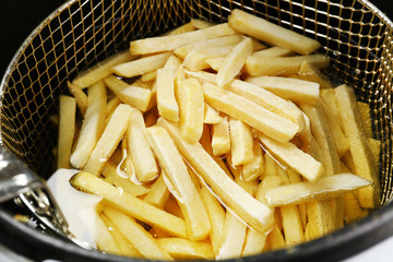 French fries in deep fryer, closeup