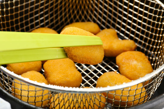 Cutlets in deep fryer, closeup
