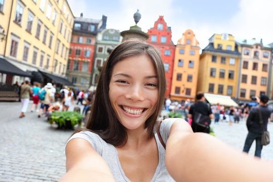 Asian woman taking self portrait selfie Stockholm