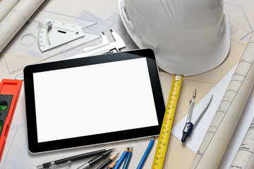 Tablet computer with construction tools and blueprints