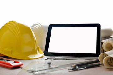Tablet computer with construction tools and blueprints
