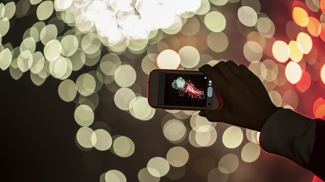 Making video with cell phone at fireworks show.