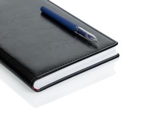 Leather notebook and pen isolated on the white