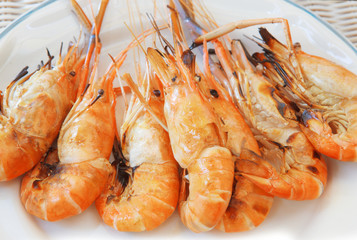 fresh water shrimp grilled on fire ready to eat on white dish