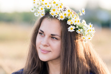 Teen girl with a wreath of daisies