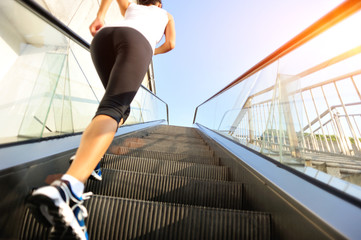 Runner athlete running on escalator stairs.  