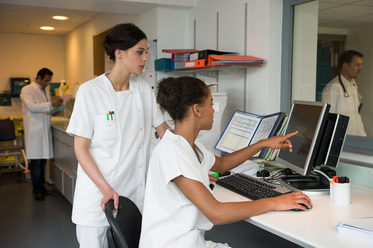 Intern nurse and doctor working in nurses office