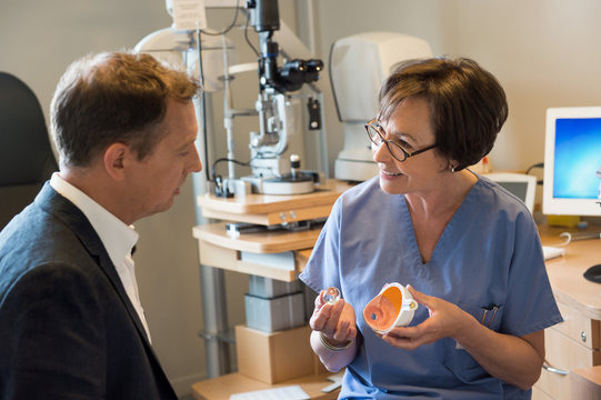 Female optometrist discussing with patient in a clinic