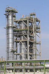 Vertical refining tower with blue sky