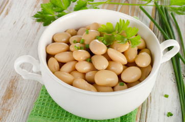Beans with fresh herbs   on  wooden table.
